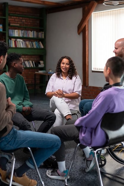 A support group meeting consisting of diverse caregivers sitting in a circle, listening attentively to one another. The setting is warm and inviting, with soft lighting and comfortable seating.