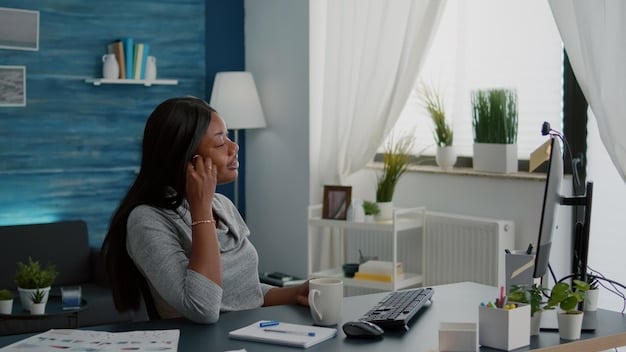 A person working calmly and efficiently on a computer in a well-organized workspace. They are smiling slightly, showing a sense of focus and contentment. The scene suggests a productive and stress-free working environment.