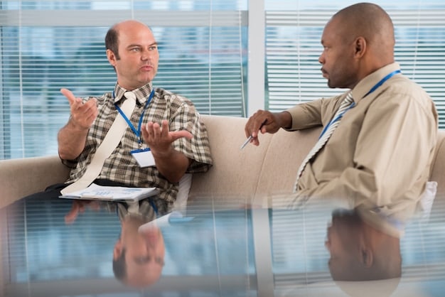 A mediator facilitating a discussion between two employees in a conference room, demonstrating a structured approach to conflict resolution.
