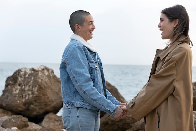 A couple facing each other smiling and holding hands in a peaceful setting. They appear to be having a calm and understanding conversation.