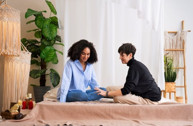 A couple sitting across from each other at a table, holding hands, looking calm and engaged in a conversation, possibly during a therapy session.