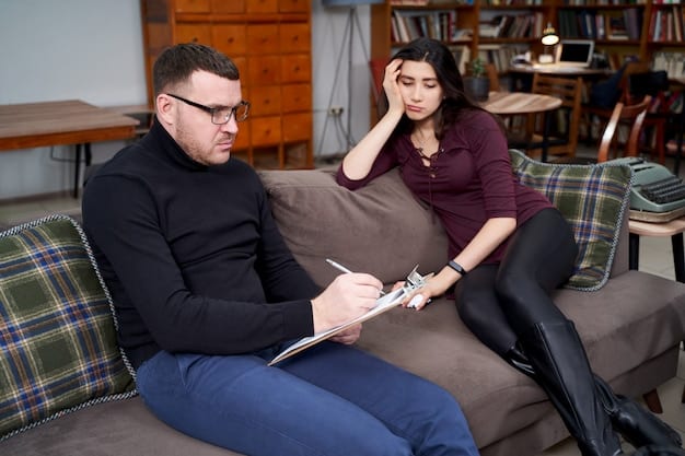 A therapist is patiently listening to a couple, noting points and observing the body language of the people in the relationship.