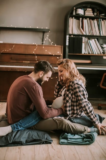 View of a couple with arms around each other and sitting intimately.