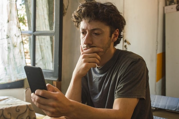 A person looking at their smartphone with a worried expression, possibly reading a text message or social media post that is causing concern.