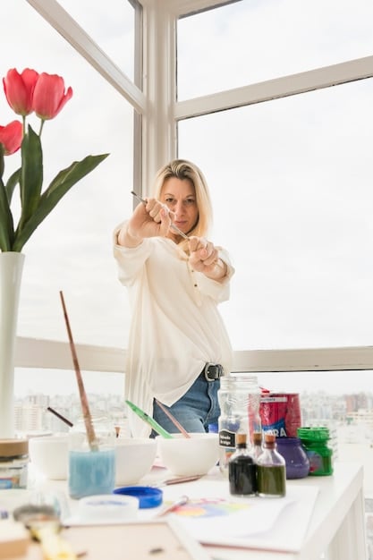 An introvert happily working on a creative project in a quiet, sunlit home studio, surrounded by art supplies and inspiring materials, showing the joy of solitude and creative expression.