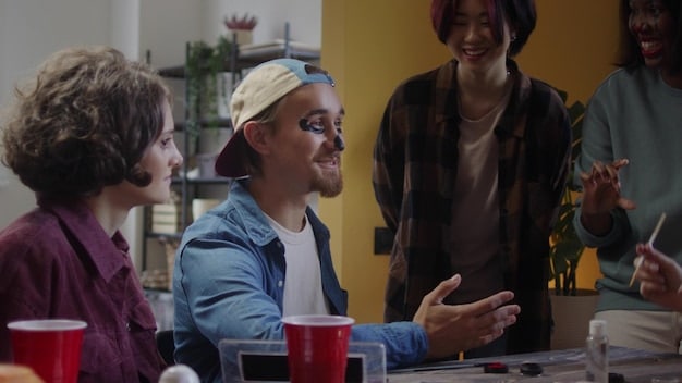 A diverse group of people interacting in a workplace, illustrating teamwork and emotional connection. The scene is collaborative and positive, with people smiling and engaged in conversation.