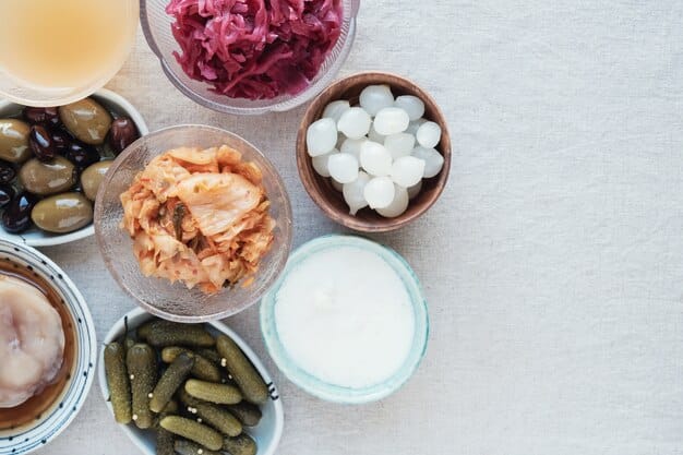 A close-up shot of various probiotic-rich foods, such as yogurt, kefir, sauerkraut, and kimchi, arranged on a wooden table. The image emphasizes the texture and freshness of the foods, with shallow depth of field to highlight the beneficial cultures.