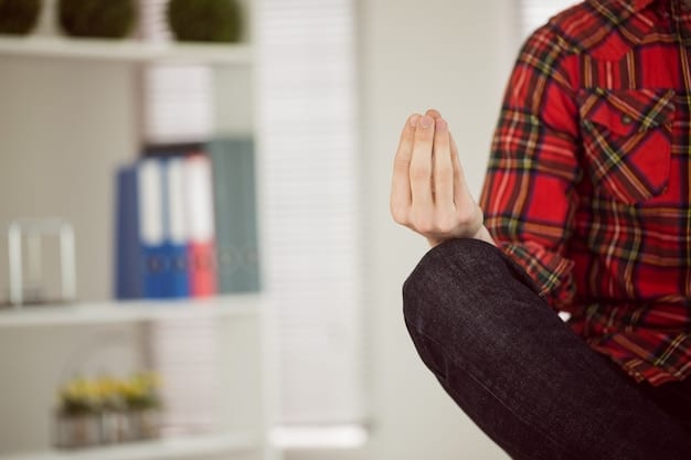 A close-up image showing hands performing a mindful breathing exercise, with soft focus on the background representing the busy office environment.