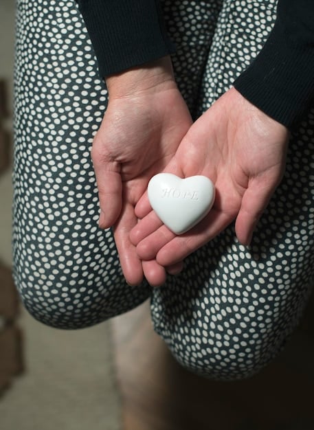 A close-up of hands holding a heart-shaped object, symbolizing love, appreciation, and the tangible expression of gratitude.