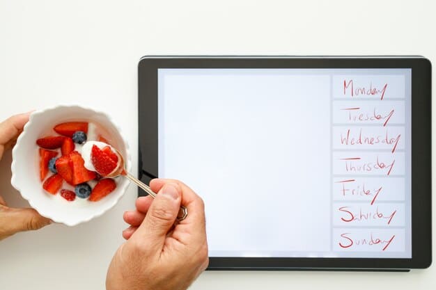 A digital tablet displaying a colorful meal plan template. The template includes sections for each day of the week, with spaces to list breakfast, lunch, dinner, and snacks. The background shows a well-stocked pantry and refrigerator, hinting at organized meal preparation.