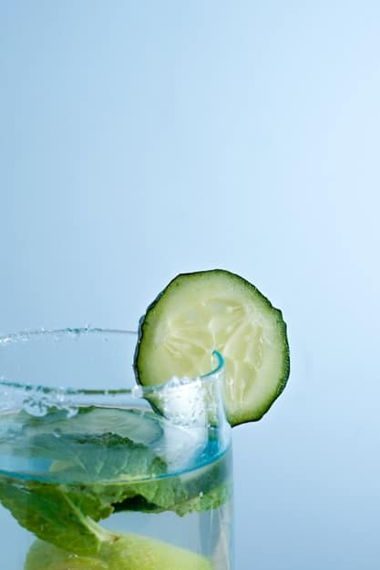 A close-up on a glass of water with slices of lemon and cucumber, illustrating the importance of hydration for energy.
