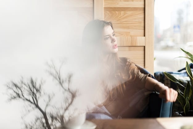 A person sitting comfortably with their eyes closed, focusing on their breath. A soft light illuminates their face, creating a peaceful and serene atmosphere. The background is blurred to emphasize the person's focus.