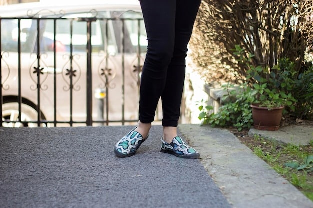 A close up of athletic shoes on a paved path in a park, representing approachable exercise.