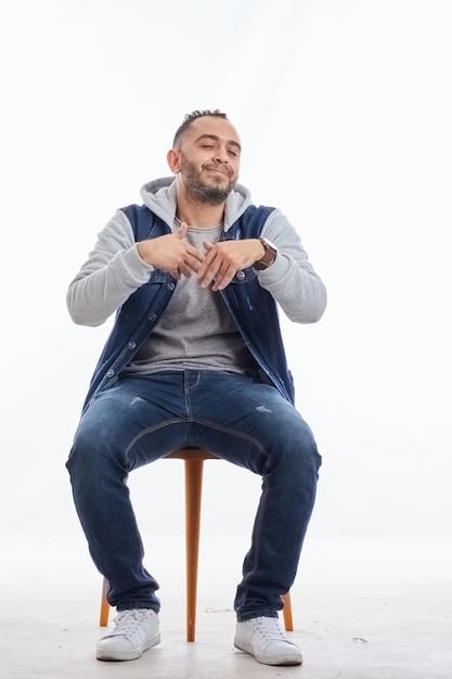 A person sitting comfortably in a chair, eyes closed, with one hand on their chest and the other on their abdomen, illustrating the practice of deep, diaphragmatic breathing. The scene is peaceful and softly lit, enhancing the sense of calm and relaxation.