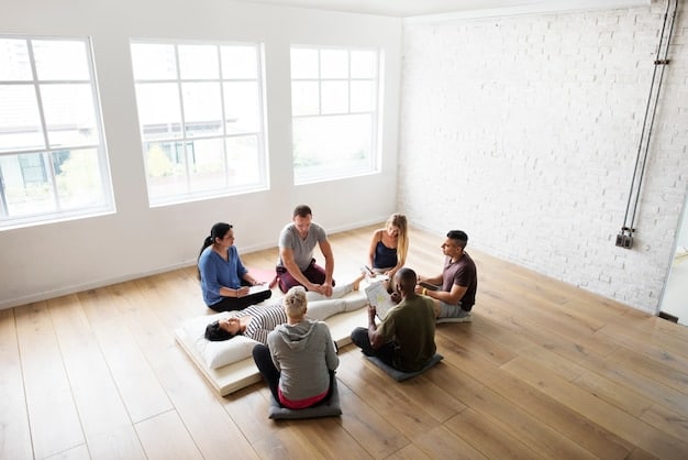 A group of people sitting in a circle, participating in a therapy session led by a therapist. The environment is comfortable and supportive, and the participants are engaged in the discussion.