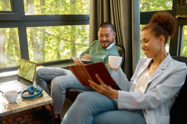 A counselor and patient are looking through books and resources dedicated to addiction treatment. They are both smiling and engaged in the conversation.