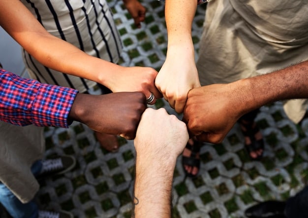 A diverse group of people supporting each other, symbolizing a strong and inclusive community.