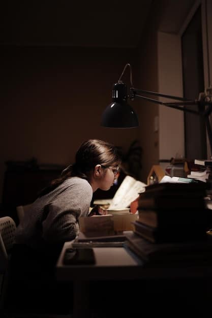 A student sitting at their desk, looking stressed with books piled up around them. The room is dimly lit, and the student is holding their head in their hands, showing the weight of academic pressure.