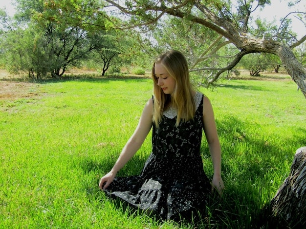 A person meditating in a peaceful garden, representing mindfulness and stress reduction.