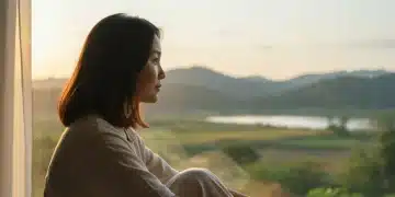 Emotional Recovery: 5 Data-Backed Habits for Resilience Serene individual reflecting by a window, symbolizing emotional healing and inner peace.