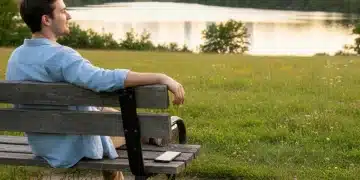 Person on park bench, phone down, mindful digital detox
