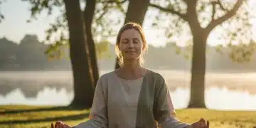 Person practicing mindfulness in a serene outdoor setting, connecting mind and body for resilience.